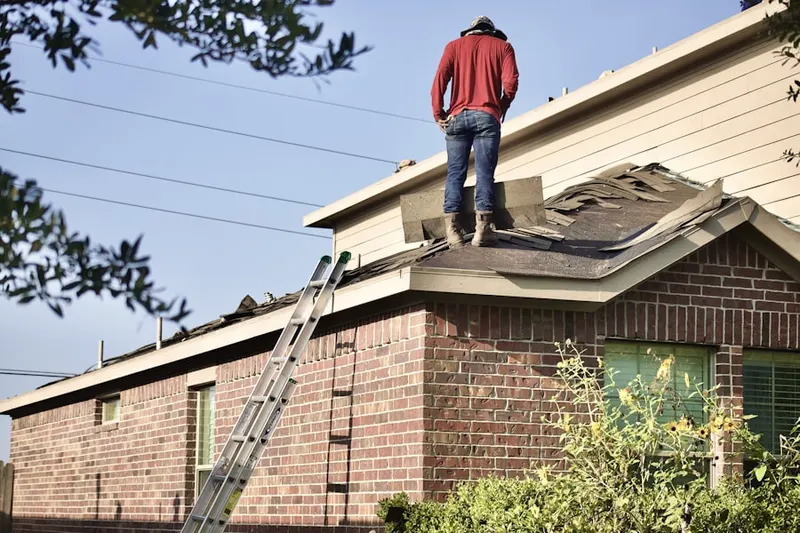 Professional roofer working on a residential roof in Soledad